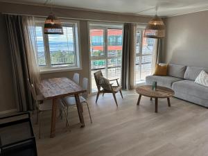 a living room with a couch and a table at Hedmarktoppen in Hamar