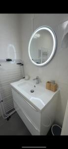 a bathroom with a white sink and a mirror at L'Échappée Occitane - Harmonie et Douceur de Vivre - Clim in Montauban