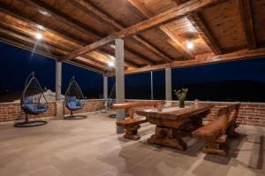 a large room with a wooden table and two chairs at Villa Castella Verde in Rogoznica