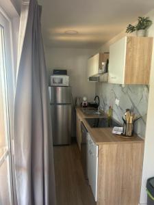 a small kitchen with a sink and a refrigerator at Mobile home La Bella in Drage +7 photos
