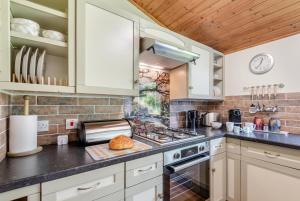 a kitchen with white cabinets and a stove top oven at 2 Bed in Keddington oc-t32411 in Louth