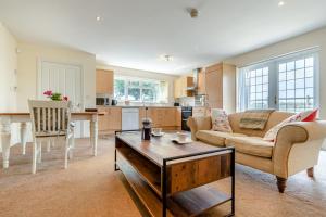 a living room with a couch and a table at 1 Bed in Flore oc-b32437 in Flore +18 photos