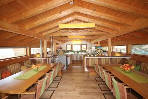 a dining room with wooden tables and benches at Alpin Chalet Flachau in Flachau