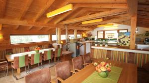 a dining room with wooden ceilings and tables and chairs at Alpin Chalet Flachau in Flachau