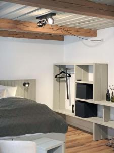 a bedroom with a bed and a book shelf at Ferienwohnung 3, Schlaf-Gut-Johannis, Flensburg in Flensburg