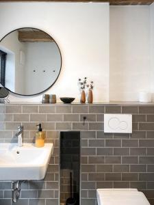 a bathroom with a sink and a mirror at Ferienwohnung 3, Schlaf-Gut-Johannis, Flensburg in Flensburg +11 photos