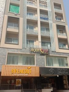 a building with a hotel cafe sign in front of it at Grande apartments 205,206 in Rawalpindi