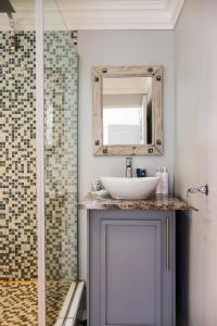 a bathroom with a sink and a mirror at Upper House Boutique Guesthouse in Clarens