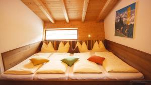 a large bed in a room with a window at Alpin Chalet Flachauwinkl in Flachau