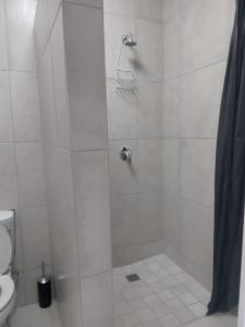 a bathroom with a shower with a toilet at 53 Tindale Road Self-Catering Accommodation in East London +26 photos