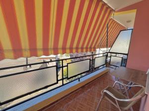 a room with a balcony with a table and chairs at Hotel Martini in Velipojë +6 photos