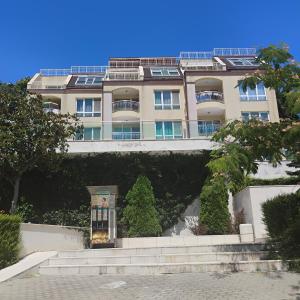 a building with a staircase in front of it at apartment VANESA in Kavarna