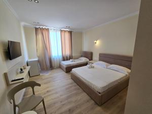 Postel nebo postele na pokoji v ubytování OKEJ Hotel