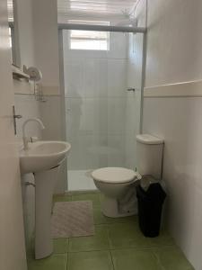 a bathroom with a sink and a toilet and a shower at Casa Cerejeiras in Campos do Jordão +50 photos