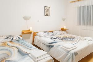 two beds sitting next to each other in a room at Hiša Vanda in Dobrovo +9 photos
