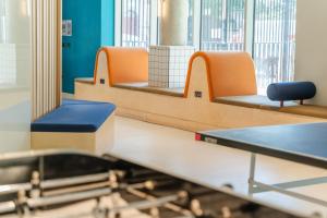 a waiting room with orange and blue chairs at Destiny Student - Parkgate in Dublin +39 photos