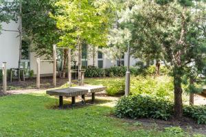 a park bench in the grass in front of a building at Destiny Student - Parkgate in Dublin