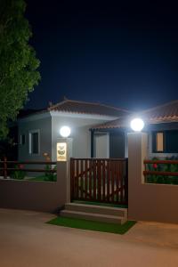 a house with two lights on the porch at night at Bella Vista Apartments in Oktonía