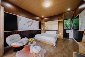 a bedroom with a bed and a tv at Tsunami bungalow in Cat Ba