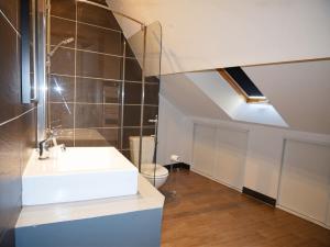 a bathroom with a sink and a toilet at La Demeure de Beauvoir - Confort & authenticité in Blois +55 photos