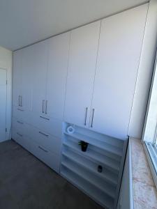 リション・レジオンにあるדירה בוטיקの白いキャビネットと窓付きの白いキッチン