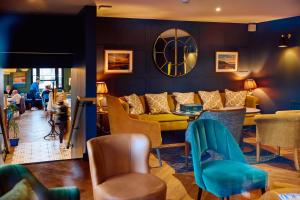 a living room with a couch and a table and chairs at The White Hart Inn in West Mersea
