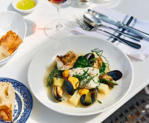 a plate of food with mussels on a table at The White Hart Inn in West Mersea +19 photos