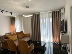 a living room with a couch and a table at DeSa Radhime in Radhimë