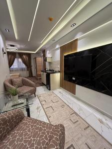 a living room with a large flat screen tv at Royal Suite Hotel - Nasr City, Cairo in Cairo