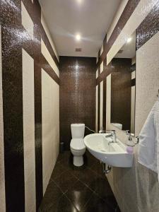 a bathroom with a toilet and a sink at Simply The Best - Vitosha blvd in Sofia +25 photos