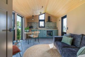 a living room with a couch and a table at Tinyhouse 32 Stavoren in Stavoren