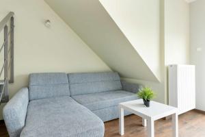 a living room with a couch and a table at Family Apartment Puck Closeto the Sea by Noclegi Renters in Puck