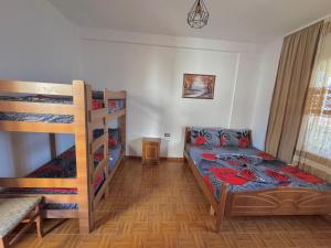 a bedroom with two bunk beds and a bed at Hotel Martini in Velipojë