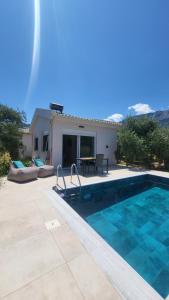 a villa with a swimming pool and a house at Casa O' - House with private Pool in Limenas
