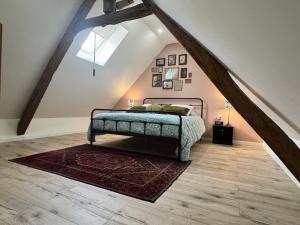 a bedroom with a bed in a attic at La Pause d'Antan 