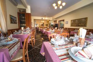a dining room with purple tables and chairs at Hotel Bristol in Lavagna