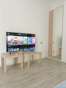 a living room with a large flat screen tv at Messina Apartments in Messina