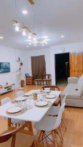 a white table and chairs in a living room at Family Island House in Casa Verde Mati City in Mati