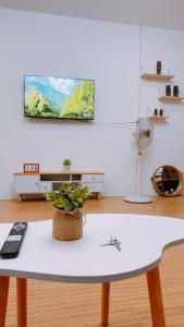 a white table with a potted plant on top of it at Family Island House in Casa Verde Mati City in Mati
