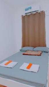 a bed with two mats on top of it at Family Island House in Casa Verde Mati City in Mati