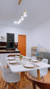 a white table with white chairs in a kitchen at Family Island House in Casa Verde Mati City in Mati +3 photos