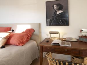 a bedroom with a desk next to a bed with a desk at Confort moderne à Sauzon avec vue sur port, accessible PMR, wifi, linge inclus - FR-1-418-184 in Sauzon