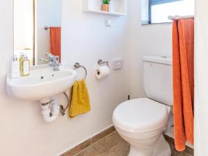 a bathroom with a white toilet and a sink at Cape Town 4U Guesthouse in Cape Town