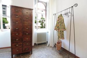 a bedroom with a dresser and a chest of drawers at Casa Zaira in Feltre