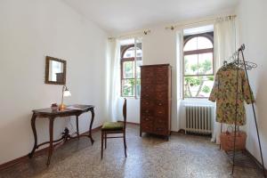 a room with a desk and a dresser and a window at Casa Zaira in Feltre