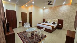 a hotel room with a bed and a table and chairs at LakeWood Gardenia Boutique Hotel in Bengaluru +50 photos