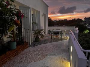a balcony of a house with a table and a sunset at Northwest Hostings 301 in Cartagena de Indias