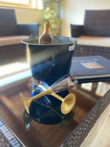 a glass container with a bottle and spoons on a table at Il Campanile in Fondi