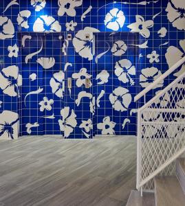 a blue tiled wall with white flowers on it at Delamar 4*Sup-Adults only (18+) in Lloret de Mar