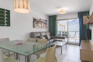 a living room with a table and a couch at Apartamentos Hipocampos Calpe Rent Apart in Calpe
